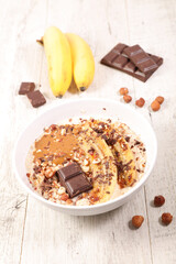 bowl of oatmeal with banana and chocolate