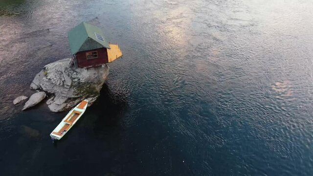 Small wooden cabin on a rock in the middle of river Drina, Serbia.	
