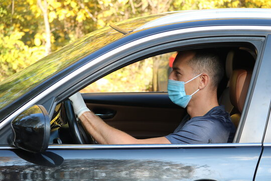 Covid  protected driver with facemark and suit