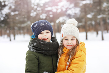 Fototapeta premium Happy family playing and laughing in winter outdoors in the snow. City park winter day.