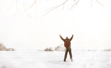 A man on a walk. Winter landscape. Tourist in winter journey.