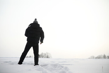 A man on a walk. Winter landscape. Tourist in winter journey.