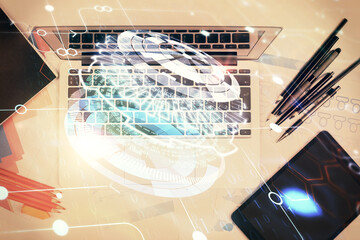 Multi exposure of data drawing hologram over topview of study desk background with computer. Concept of technology.