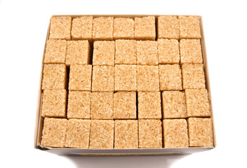 Refined sugar cubes on white background. Brown sugar cubes in background