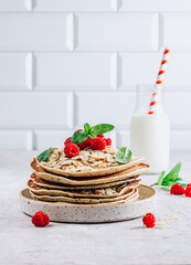 Pancakes with raspberry on white kithen background. Fresh pancakes with almonds and berries.