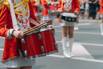 Young girls drummer at the parade. Street performance. Majorettes in the parade