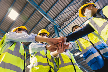 Teamwork unity concept, Group of industrial worker in safety suite hand stack celebrate successful or deal commitment