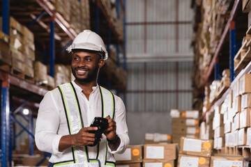 Black male staff using digital barcode scanner working checking stock in logistic warehouse