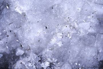 Crashed ice concrete surface background texture. Frozen ice surface of a lake in sunset