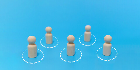 New normal. group of wooden crowd maintain social distancing to prevent from covid-19 on blue background, new normal lifestyle, virus prevention, self quarantine, social distance concept