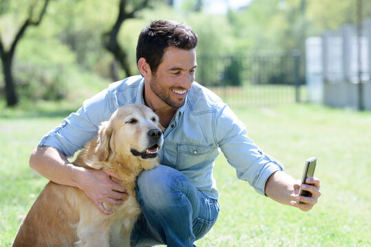 man and his dog friend taking selfie