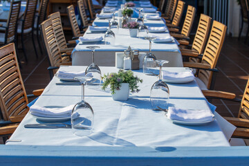 Elegant table setting with fork, knife, wine glass and napkin in restaurant