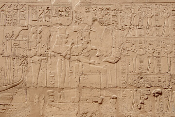 Ancient Egyptian murals and writings on the stone walls of the Karnak Temple in Luxor