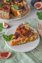 Home made autumn quiche with pumpkin and figs on a table