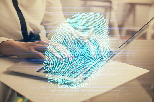 Double exposure of woman hands typing on computer and fingerprint drawing. Security concept.