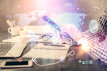 Multi exposure of man's hands holding and using a digital device and map drawing. International...