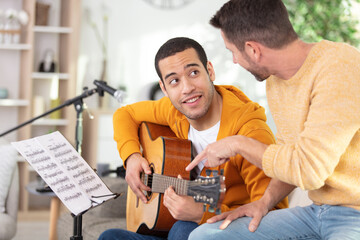 young man having a guitar lesson