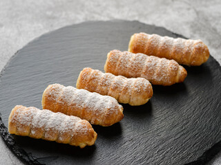  tubes cakes on a black board
