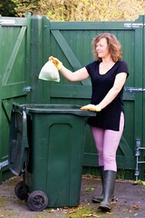 Woman with recycling bin.