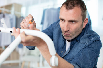 man with a tool during furniture assembly