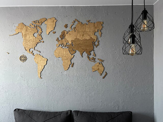 Loft-style interior with a wooden world map on the wall and black metal fixtures