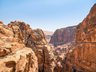 Mountain wall of red sand rock that surround the ancient city of Petra, Jordan. Rocky desesrt landscape