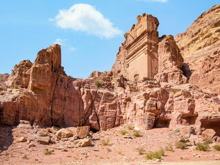 Fototapeta premium Tomb of 'Unayshu a well preserved tomb carved in red rock in the ancient city of Petra, Jordan