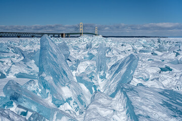 Fototapeta na wymiar Blue Ice blocks pile up at the Mackinac Bridge, near Mackinaw City, Michigan.