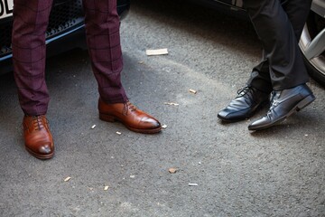 feet of two men talking