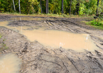 landscape with muddy and sticky forest road, dirty field road, autumn