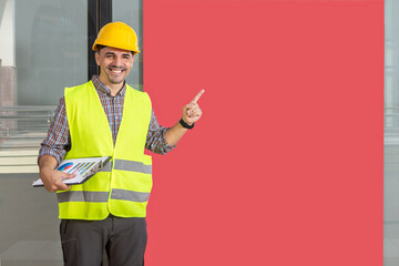 worker smiling and fingering a red banner