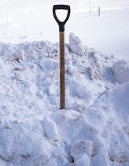the shovel is stuck in a large snowdrift