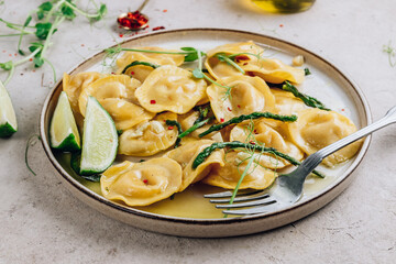 Italian cheese ravioli with roasted asparagus in herbed lemon butter sauce