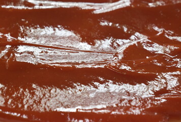 close up of tomato sauce or ketchup spreading on plate