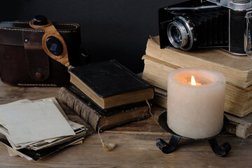 old family photos 50s, 40s, retro camera, books, glasses for solar eclipse on wooden table, concept...