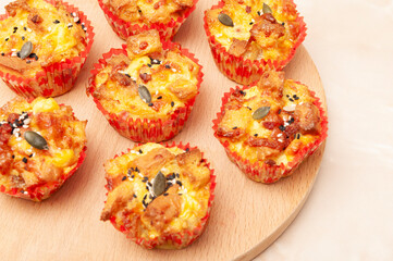 Muffins with eggs, seed and bread on a table, baked in the oven