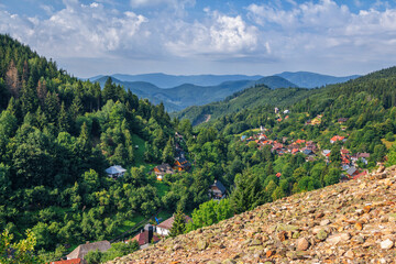
Scenic view of beautiful mountain village - Spania Dolina in Low Tatras, Slovakia. Small church, colorful house roofs and lush forest
