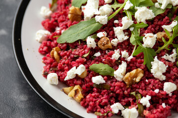 Bulgur salad with beetroot, walnuts, arugula and feta cheese. Healthy diet food