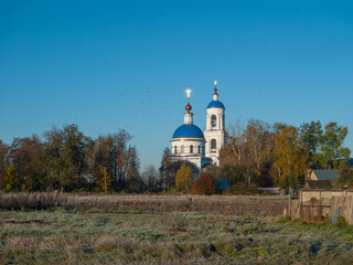 A church with birds flying around it