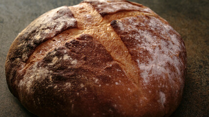 Freshly baked natural bread is on the kitchen table.