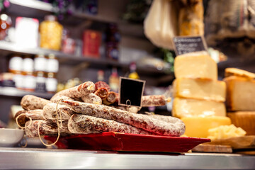 Italian food market with cheese and pepperoni, salsicella dolce, Tuscan delicatessen stall display,...