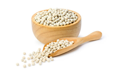 White pepper seeds (peppercorn) in wooden bowl and scoop isolated on white background.