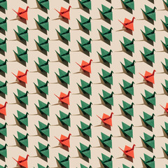 Minimal Christmas season pattern idea with red and green origami cranes on pastel beige background. Creative decoration concept, visual geometric composition.