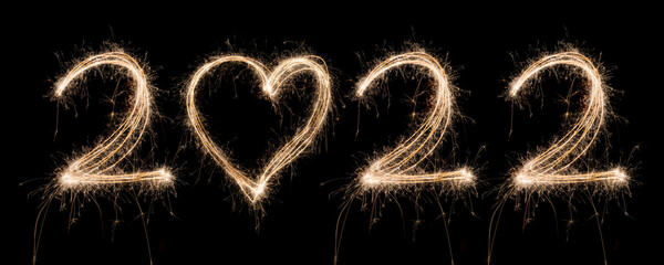2022 New Year Sparkler Light drawn in numbers and heart shape for happy new year at night time to celebrate special holiday occasion, Christmas party, diwali, independent day or important event