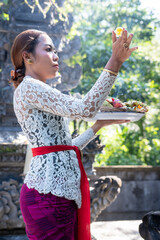 Naklejka premium Young Balinese girl praying at Hindu Temple, Bali