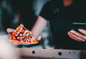 woman Hand takes a slice of chicken Pizza in paper box in cafe