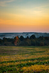 sunset over the Ukrainian village. garbage smoking season. Ukrainian village in the smoke. smoke over the village. the bell towers of the church shine at sunset. Ukrainian village. 