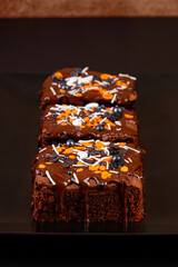 Closeup homemade brownie on a dark plate. Shallow focus.