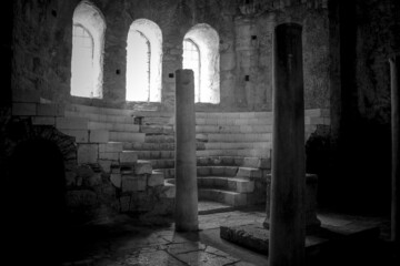 dark antique interior of an ancient temple. black and white.