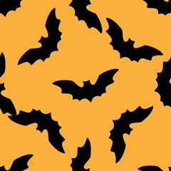 seamless pattern silhouette of a black bat on an orange background for a Halloween design template. The pattern of a soaring bat with pointed ears is drawn in the style of doodles randomly located on 